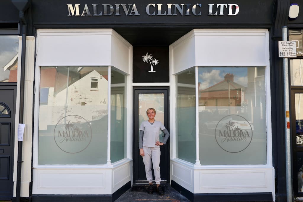 The Maldiva Clinic Ltd storefront on Constance Street, Newport, with Tricia in the doorway