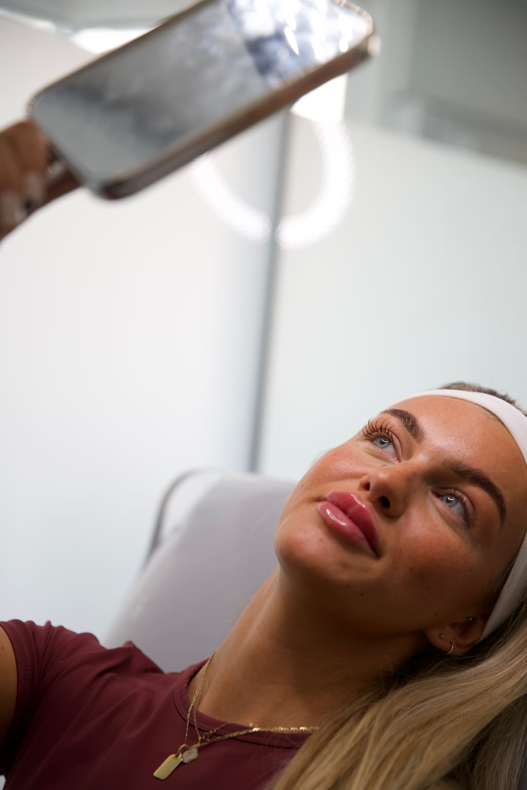 A client admiring her refreshed look after treatment
